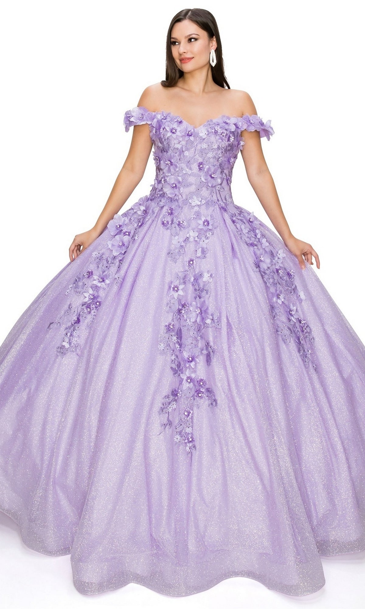 A woman wears the Quinceanera Ball Gown 8020J, a sparkling lavender off-the-shoulder dress featuring 3D floral accents and a full glitter skirt.